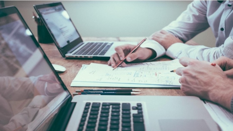 Business executives review sales and customer data to create a quality sales acceleration strategy